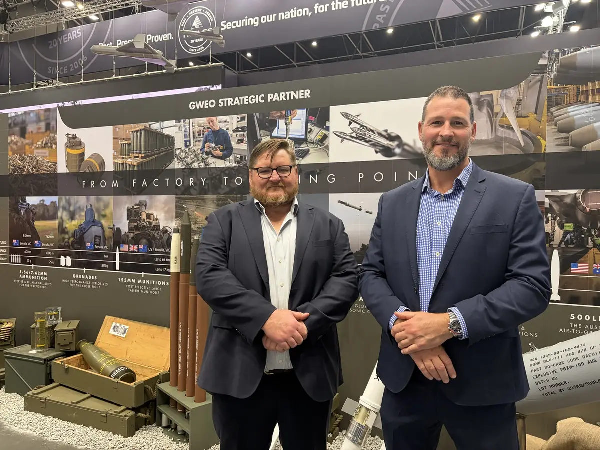 Matthew Shea, Managing Director, and Matt Hanlon, General Manager at Hammerstone, at the Thales Australia stand at Land Forces 2026, in front of a From Factory to Firing Point munitions display
